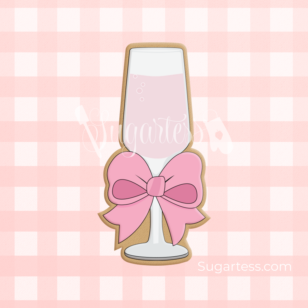 Sugartess custom cookie cutter in shape of a champagne or wine flute glass with a large bow.