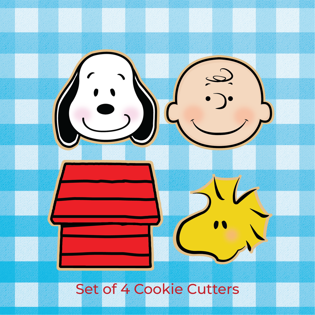 Sugartess custom Peanuts characters cookie cutters in shape of Snoopy, Charlie B., and Woodstock heads, and Snoopy's dog house.