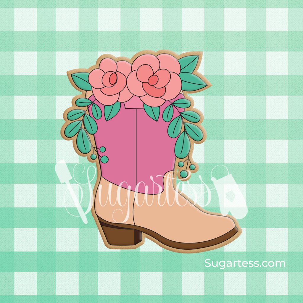 Sugartess custom cookie cutter in shape of a boot with roses and greenery on top.
