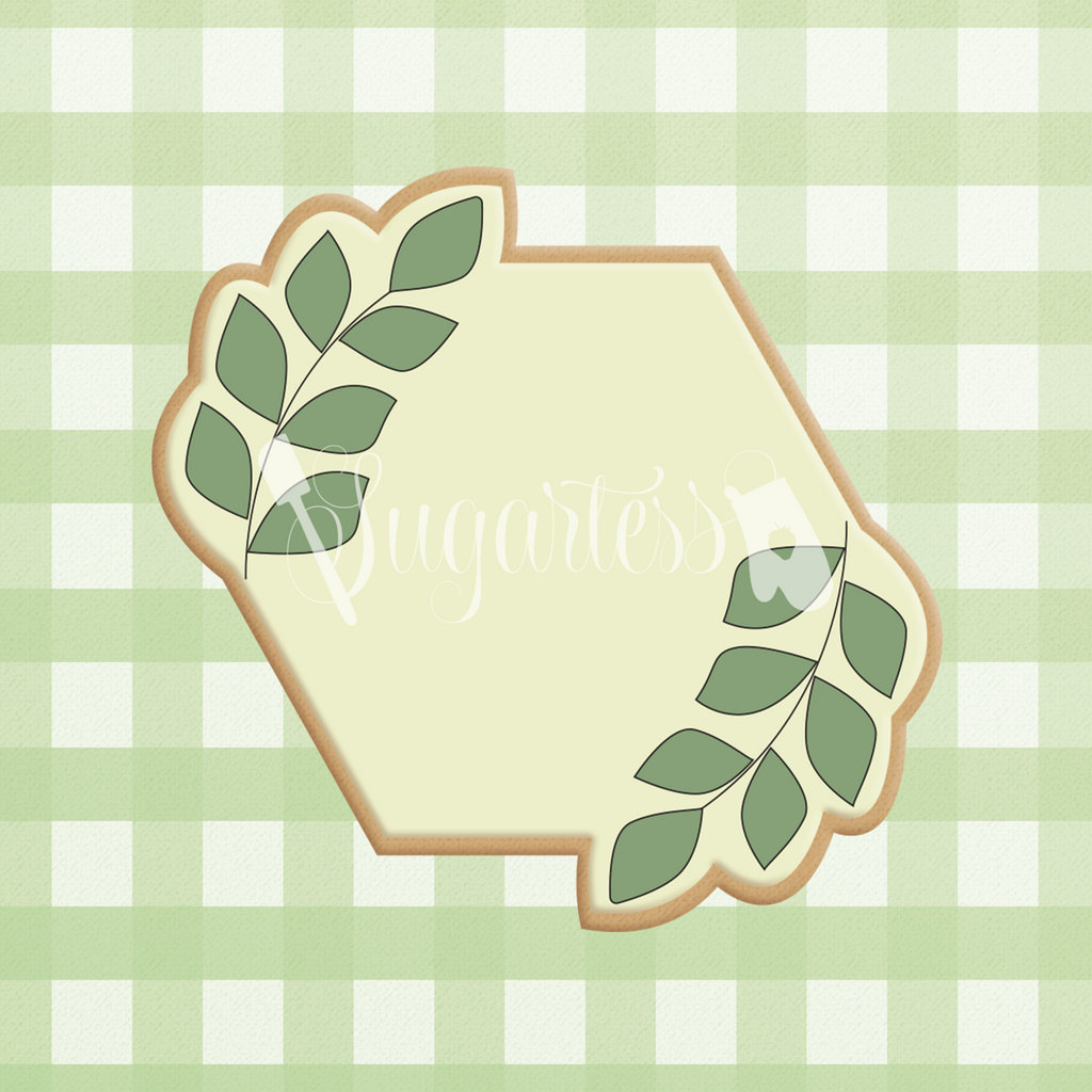 Sugartess custom cookie cutter in shape of an hexagonal geometric plaque with greenery.