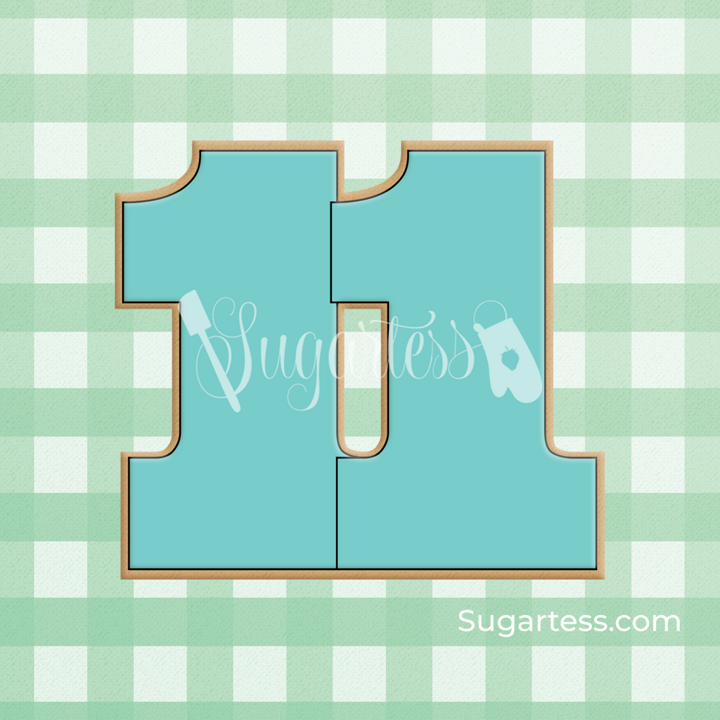 Sugartess custom cookie cutter in shape of number eleven.