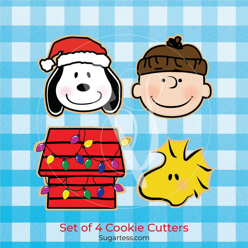 Sugartess holiday custom cookie cutter in shape of cartoon Peanuts characters: Charlie B, Snoopy dog, dog house, and Woodstock bird.
