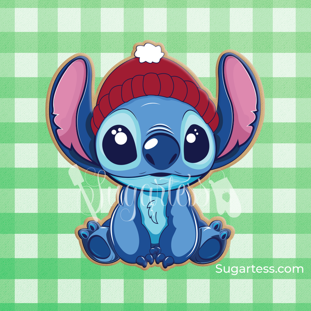 Sugartess custom cookie cutter in shape of Stitch Hawaiian Alien sitting down and wearing a red Winter Hat.