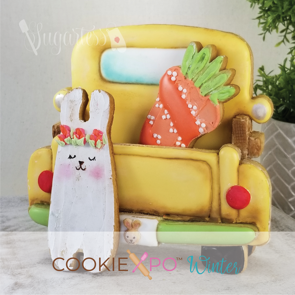 Sugartess custom cookie cutter set for Cookiexpo 2021 in shape of the back part of a classic pickup truck . 3D cookie truck is painted in yellow with green bumper and includes a tall bunny and carrot,