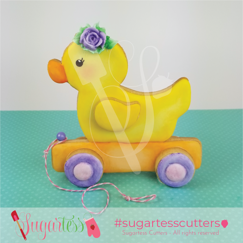 Sugartess pull along girl toy duck with rose headpiece decorated 3-D cookie.