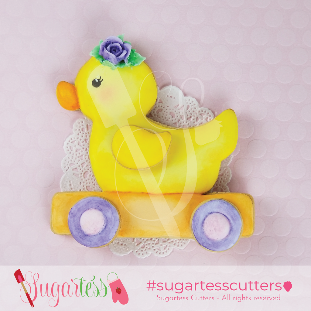 Sugartess pull along girl toy duck with rose headpiece decorated cookie.