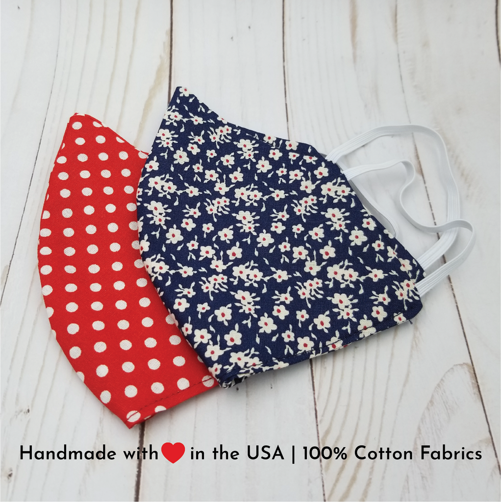 Handmade reusable and washable 100% cotton fabric face masks mouth covers. 2 prints available: red and white polka dots and navy blue and small white flowers with tiny red center.