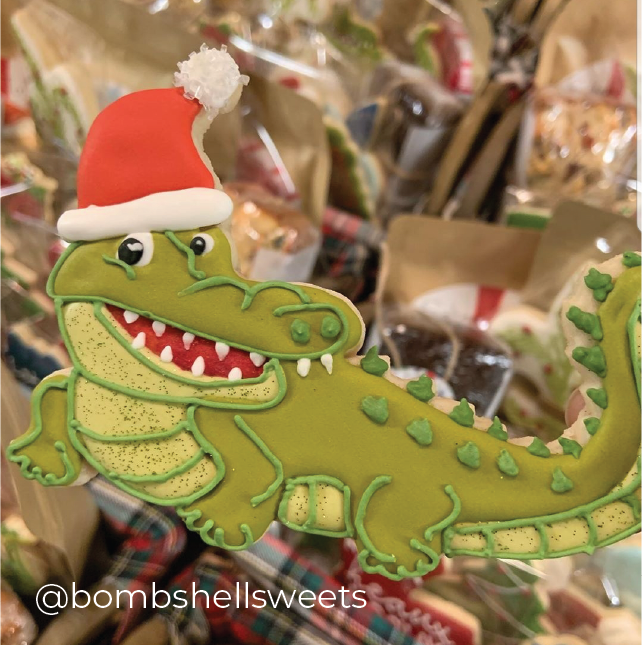 Sugartess custom cookie cutter in shape of an alligator with a Santa hat.