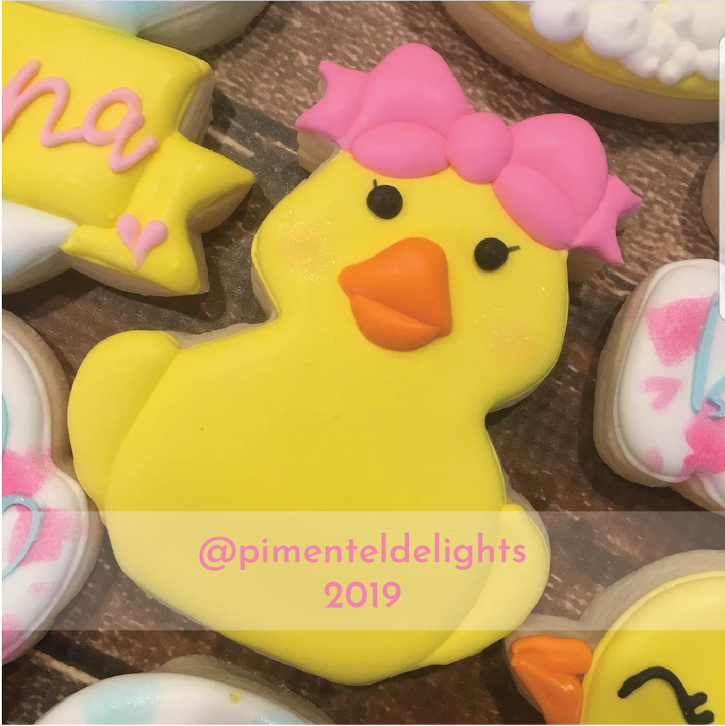 Rubber girl duck with bow decorated cookie.