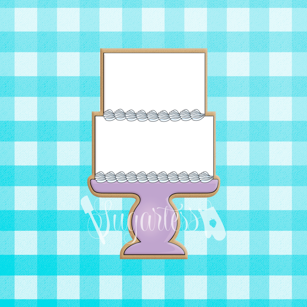 Sugartess custom cookie cutter in shape of a two-tier cake on a purple stand.