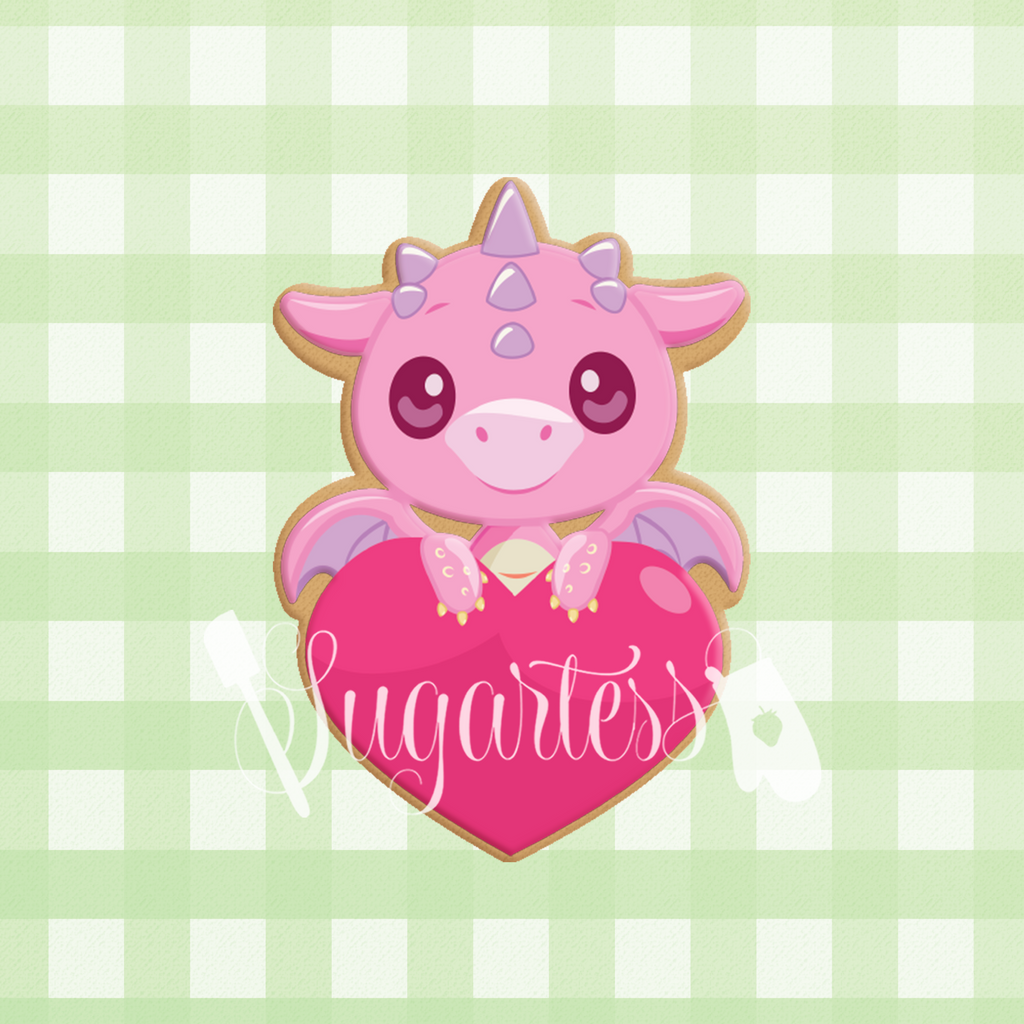 Sugartess custom cookie cutter in shape of baby dragon over heart.