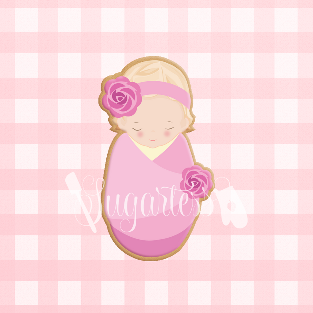 Sugartess custom cookie cutter in shape of sleeping baby girl wrapped in swaddle blanket.