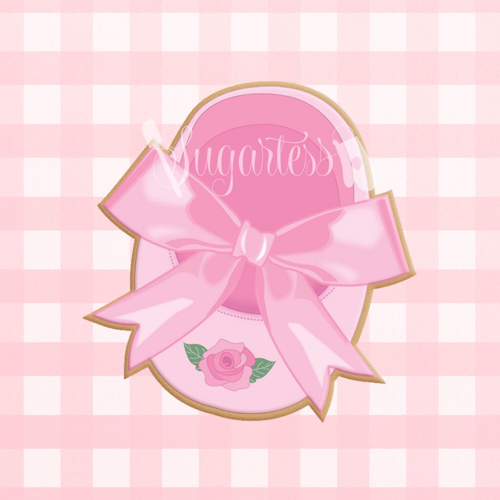 Sugartess custom cookie cutter in shape of a baby shoe with a ribbon bow.