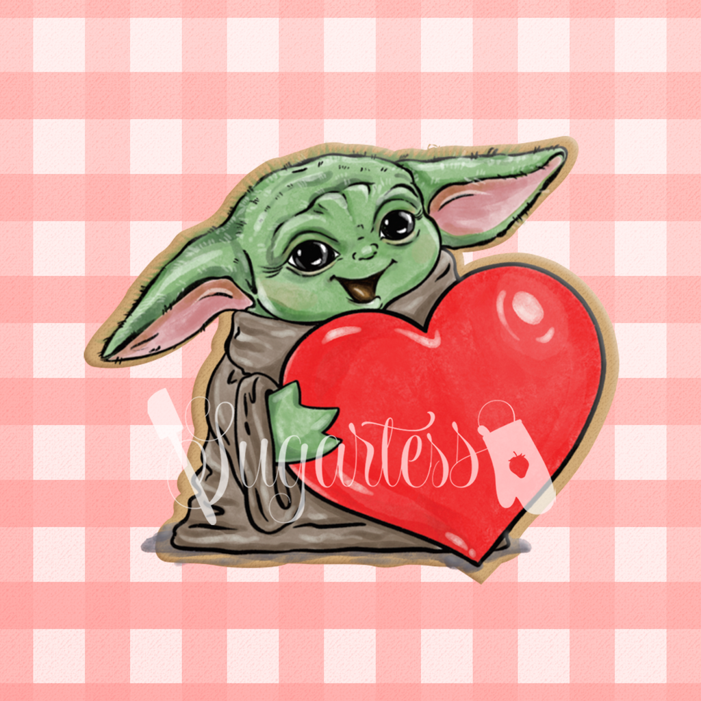 Sugartess custom cookie cutter in shape of space baby Yoda with heart.