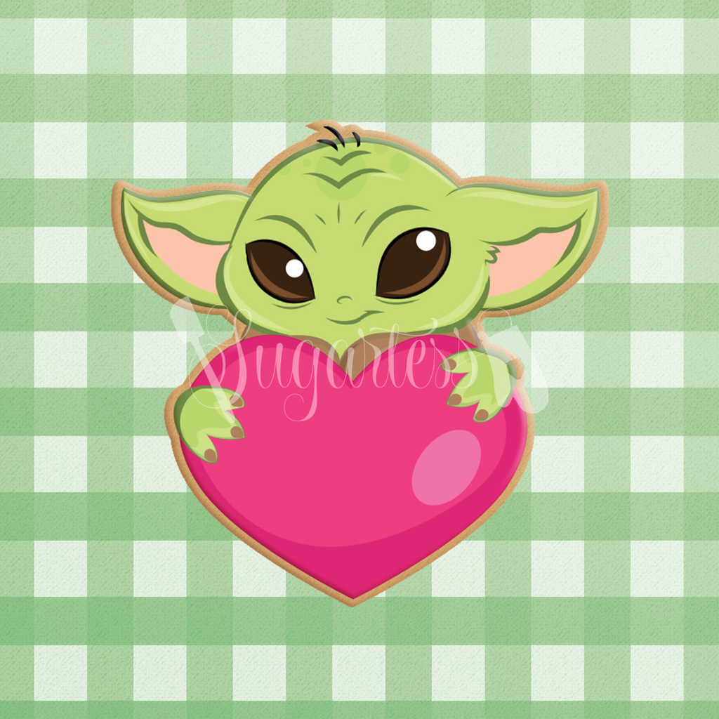 Sugartess custom cookie cutter in shape of Baby Yoda holding heart.