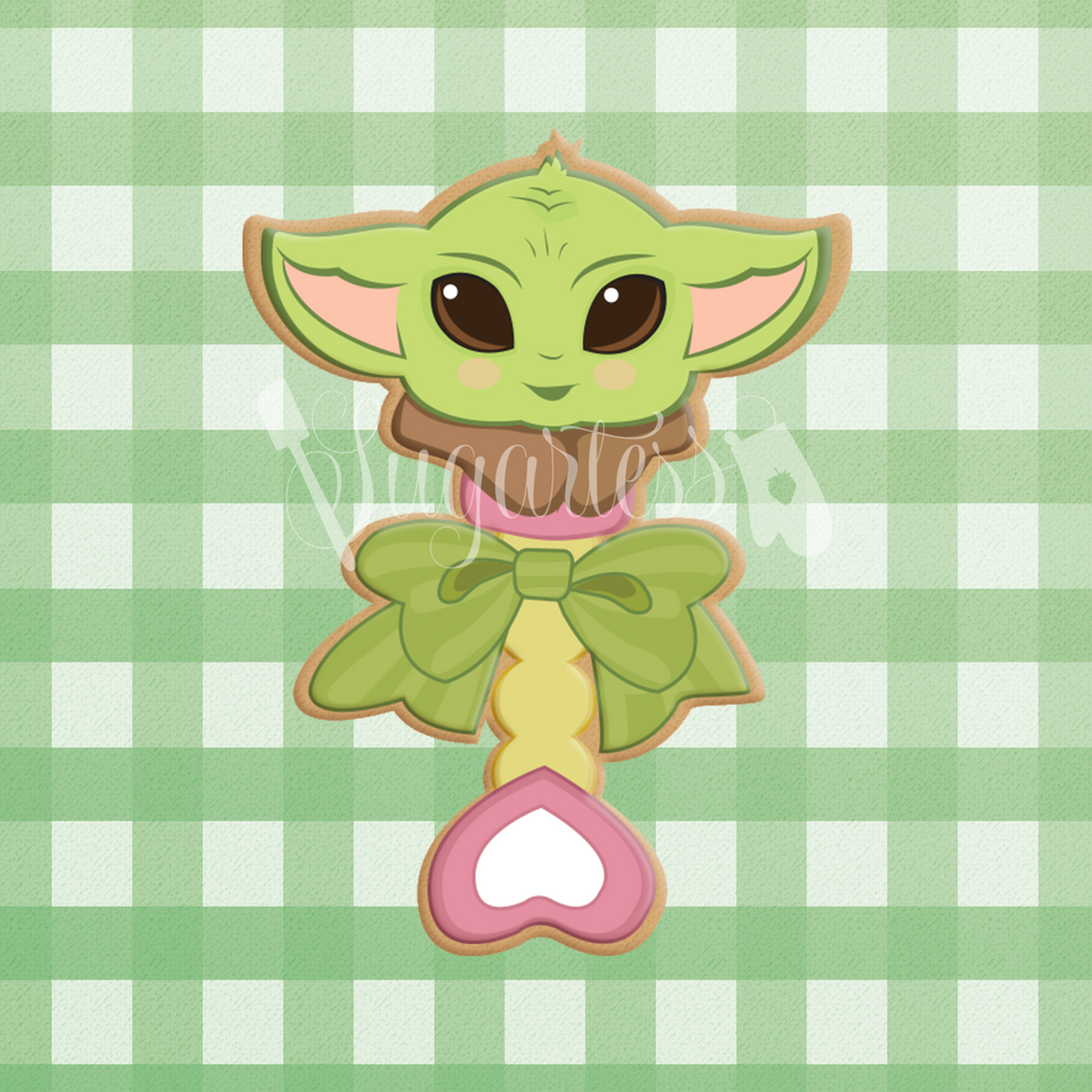 Sugartess custom cookie cutter in shape of Baby Yoda toy rattle.