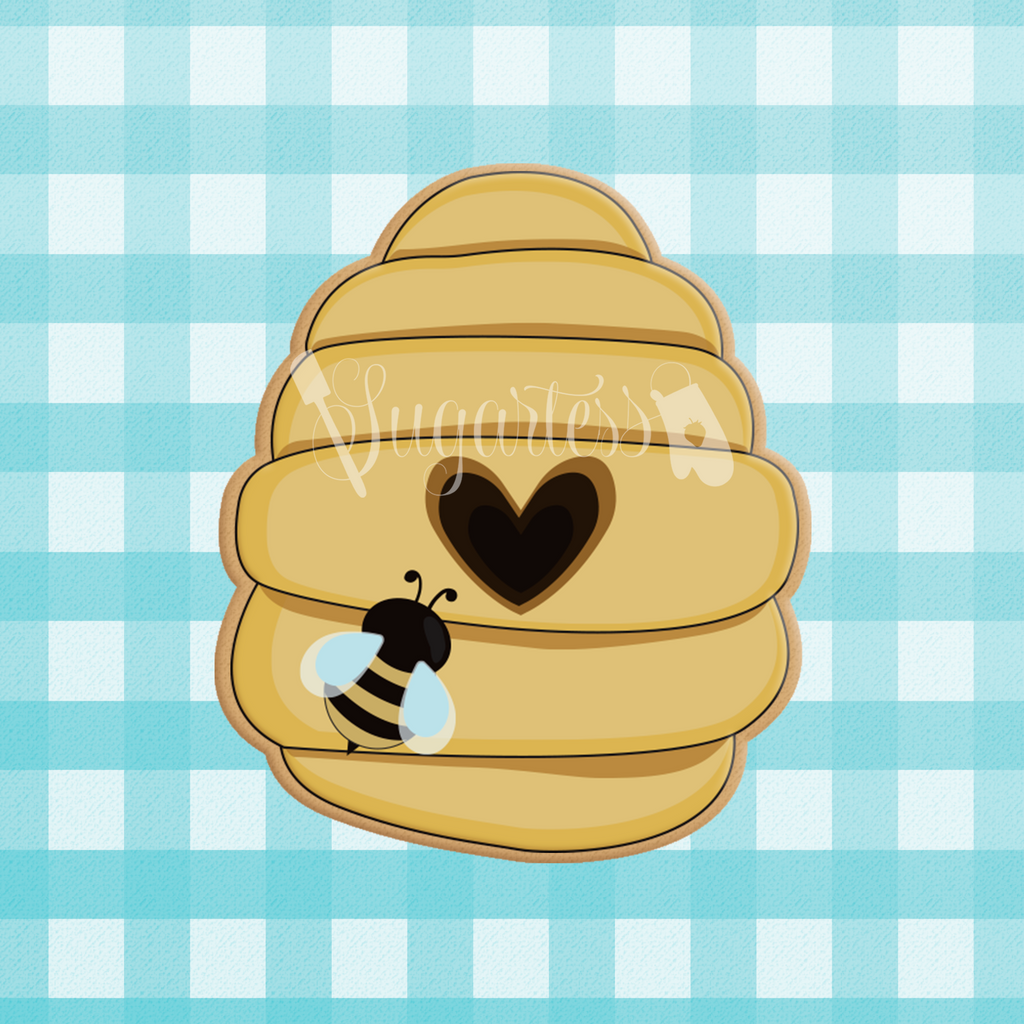Sugartess custom cookie cutter in shape of beehive with heart-shaped center door.