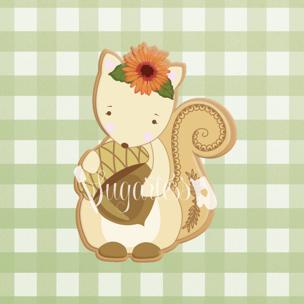 Sugartess custom cookie cutter in shape of woodland squirrel with floral headpiece and holding acorn.