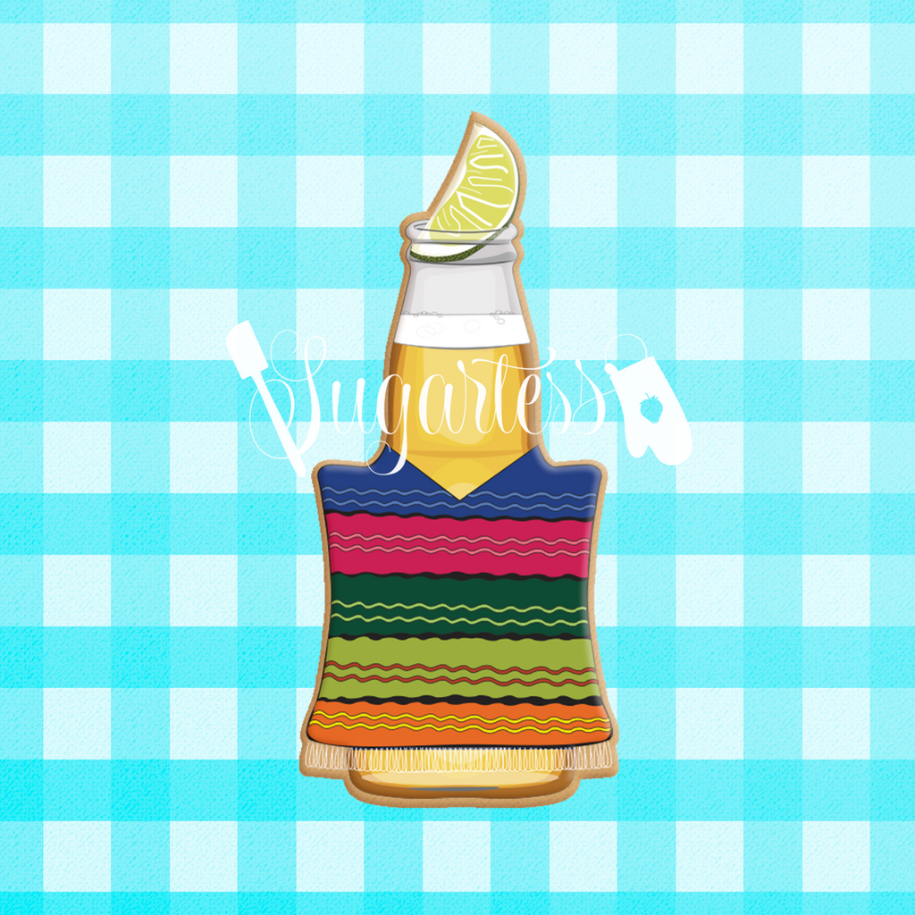 Sugartess custom cookie cutter in shape of chubby beer bottle with Mexican poncho and lemon wedge on top.