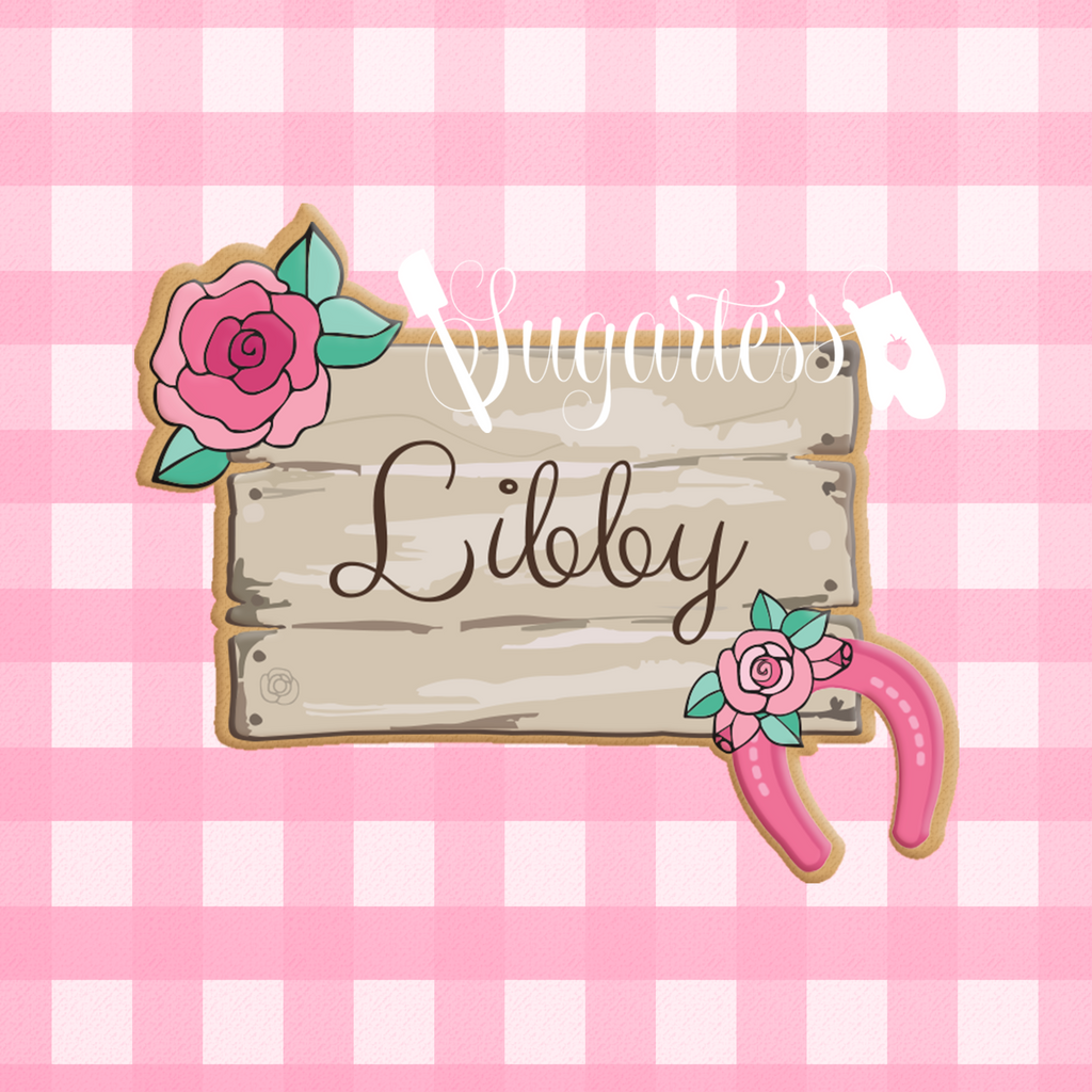 Sugartess custom cookie cutter in shape of a cowgirl wood plank name tag or plaque decorated with a rose and horseshoe.