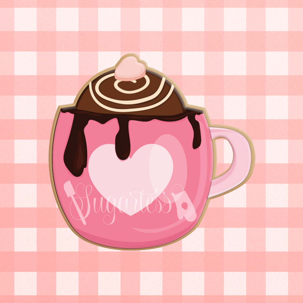 Sugartess custom cookie cutter in shape of a hot chocolate bomb in a pink cup.