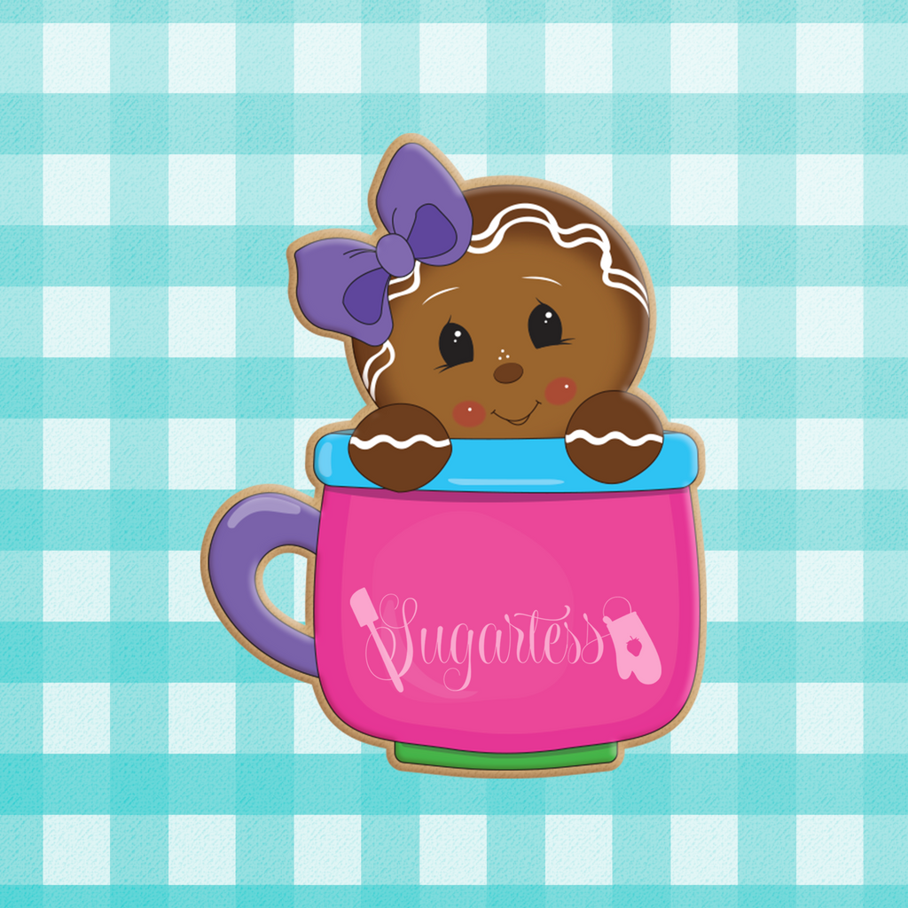 Sugartess custom holiday cookie cutter in shape of a gingerbread girl with head bow peeking out of a mug.