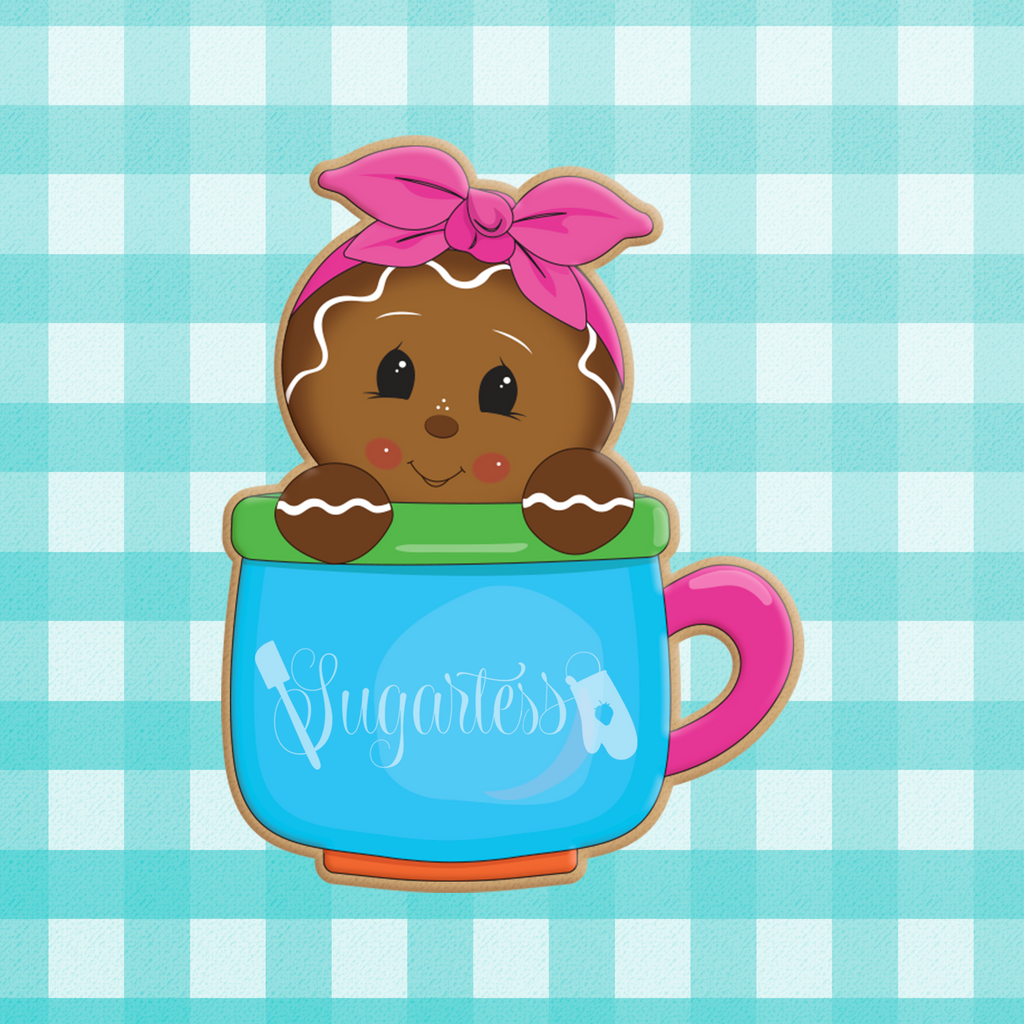 Sugartess custom holiday cookie cutter in shape of a gingerbread girl with headband peeking out of a mug.