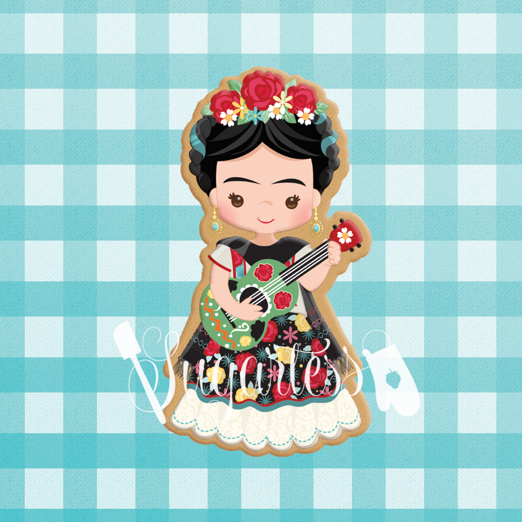 Sugartess custom cookie cutter in shape of Frida Khalo playing guitar.