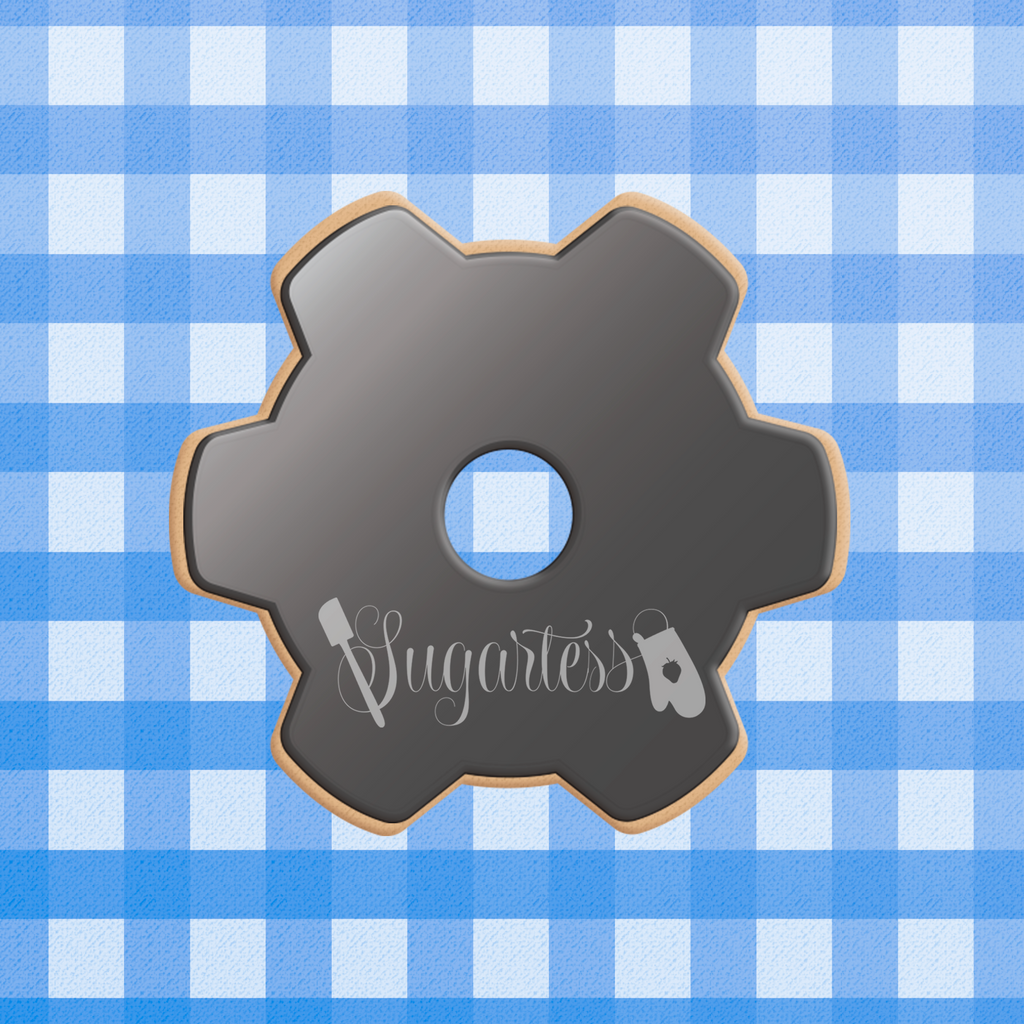Sugartess custom cookie cutter in shape of a metal gear part.