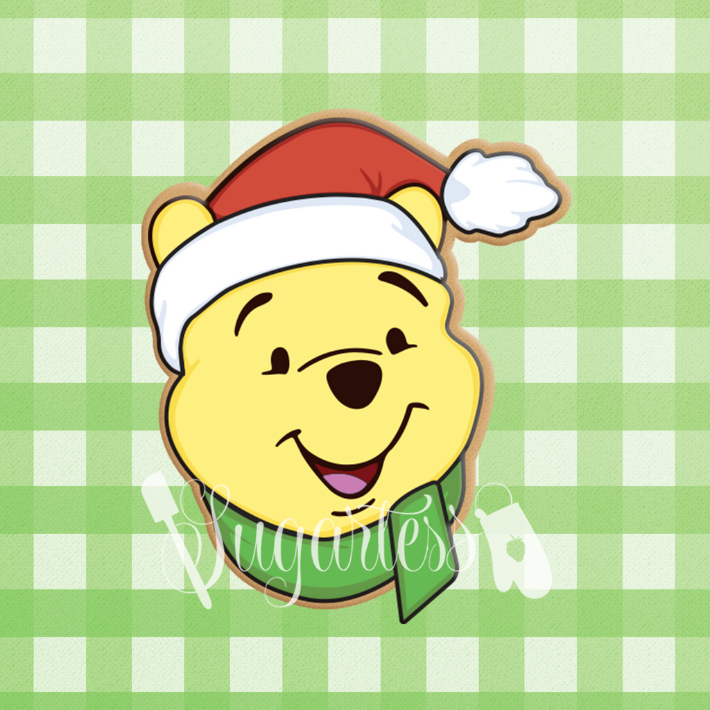 Sugartess custom cookie cutter in shape of Winnie the Pooh head with holiday hat and scarf.