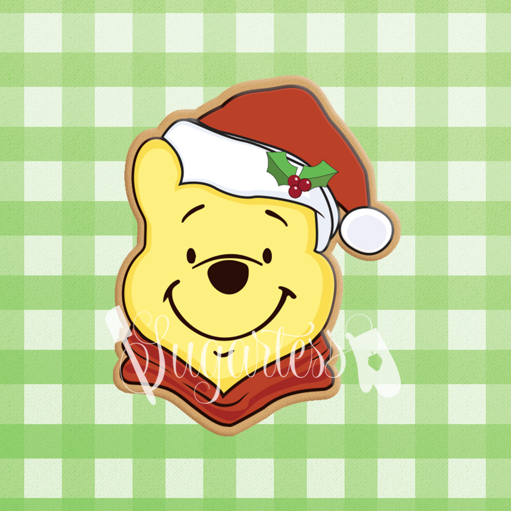 Sugartess custom cookie cutter in shape of Winnie the Pooh head with holiday hat.