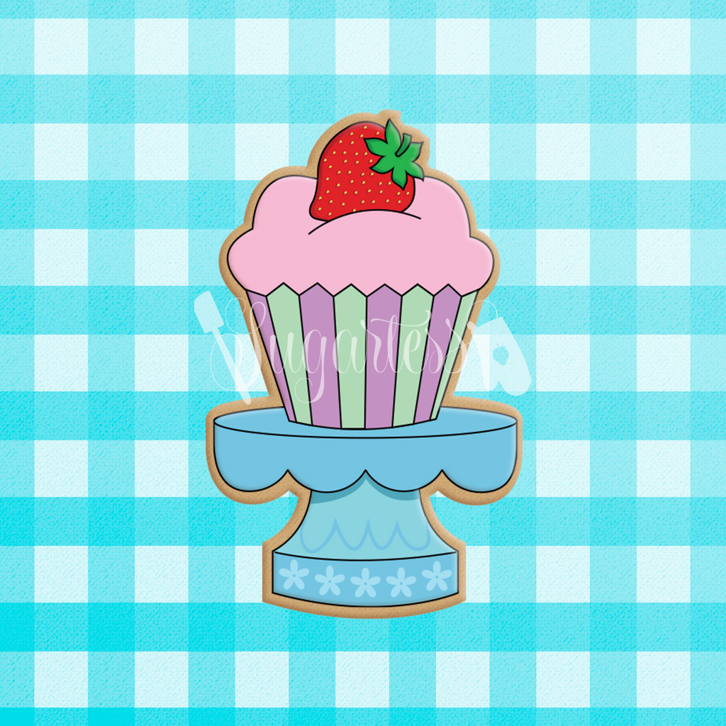 Sugartess custom cookie cutter in shape of a mini blue stand with cupcake on top.