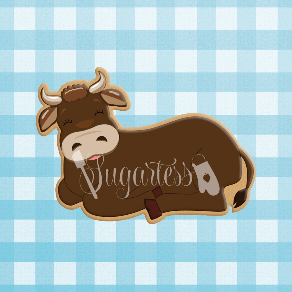 Sugartess custom cookie cutter in shape of an ox, bull or cow lying down.