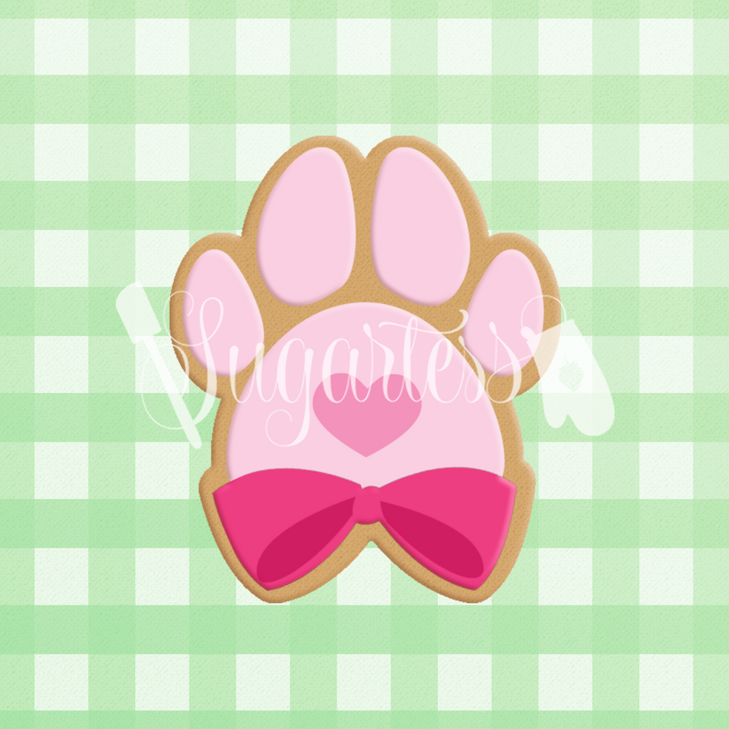 Sugartess custom cookie cutter in shape of paw print with bow.