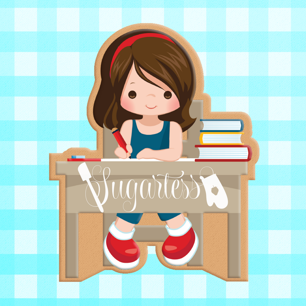 Sugartess custom cookie cutter in shape of school girl student sitting on desk.