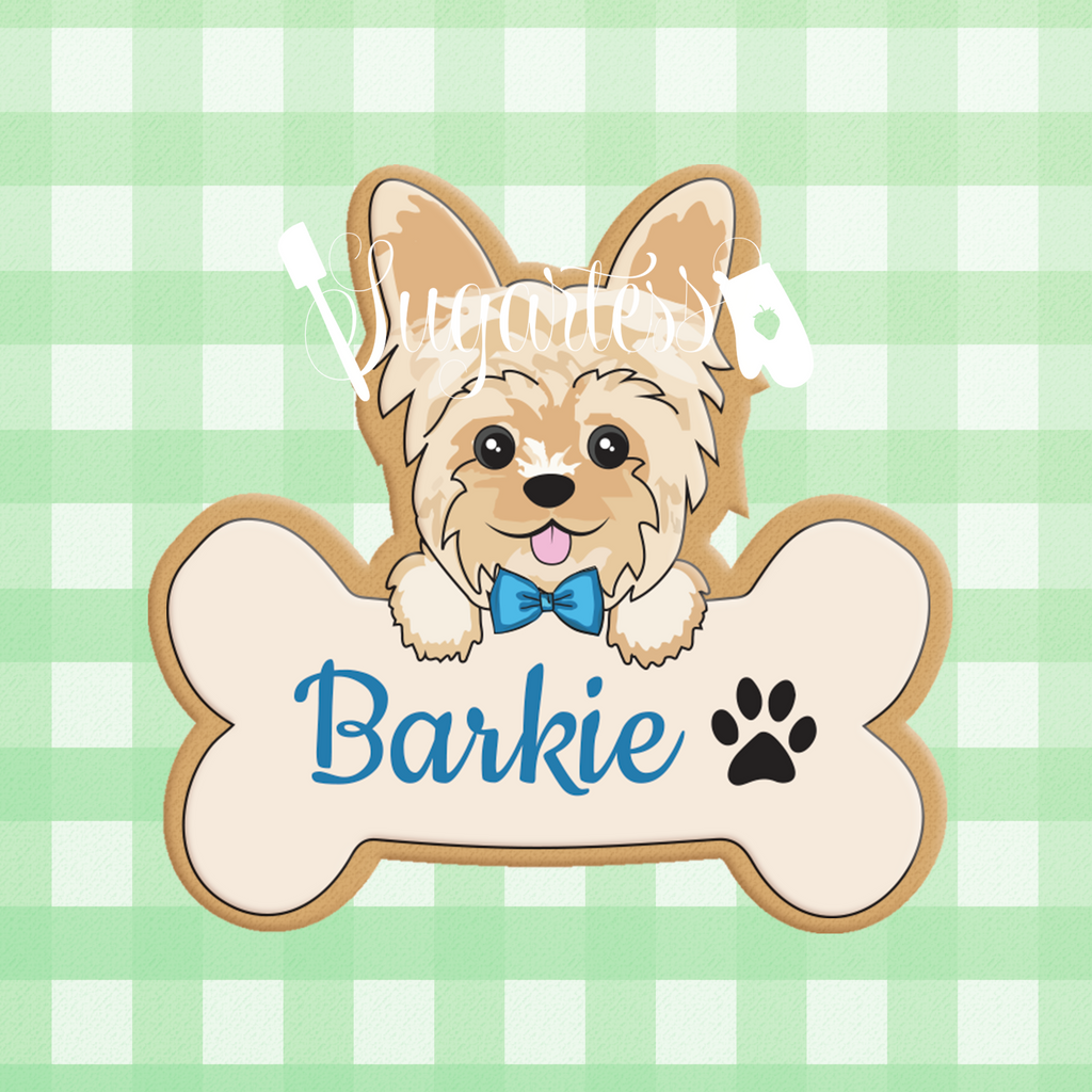 Sugartess custom cookie cutter in shape of a bone name plaque with boy Yorkie puppy dog head on top.